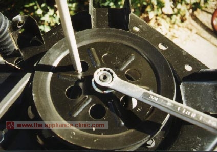 Remove nut from transmission shaft